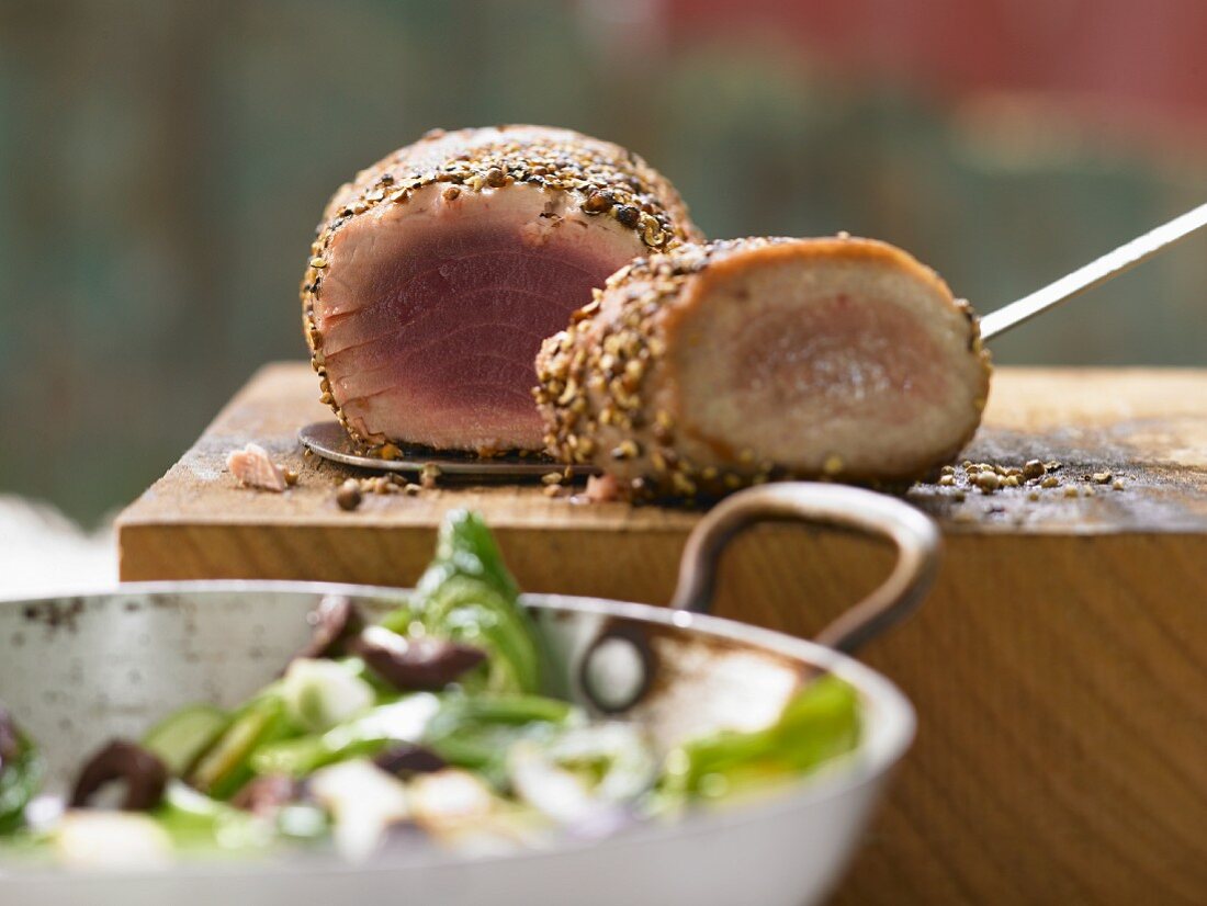 Tuna steaks in a peppercorn crust with olives and leeks