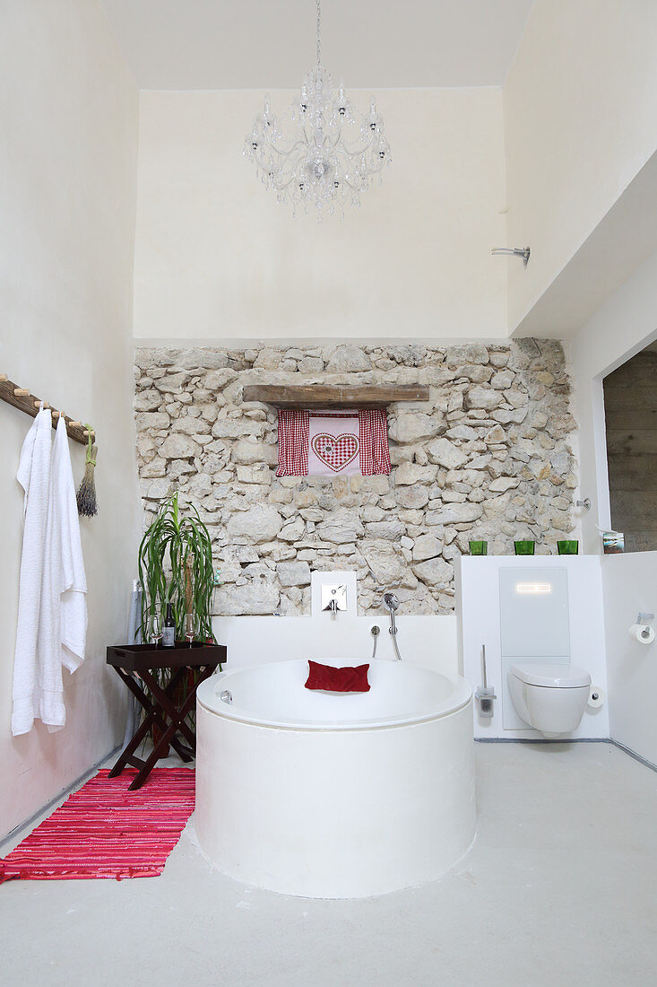 Exposed rustic masonry in renovated bathroom