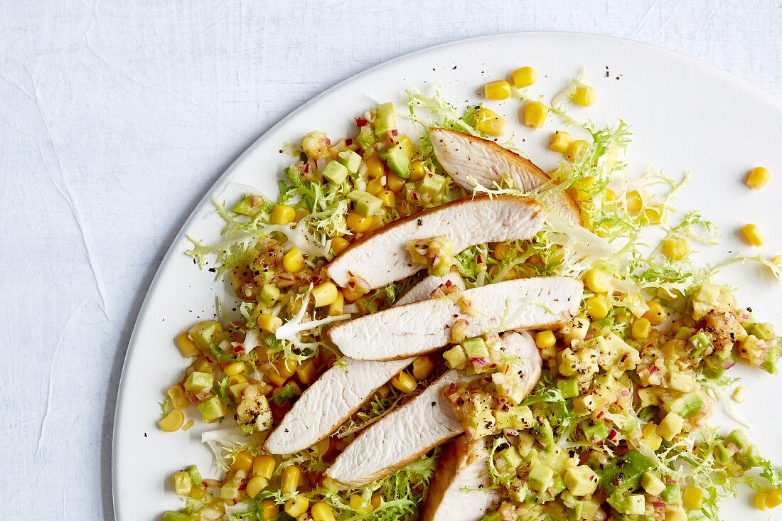 Roast turkey strips on a bed of sweetcorn and avocado salad with salsa