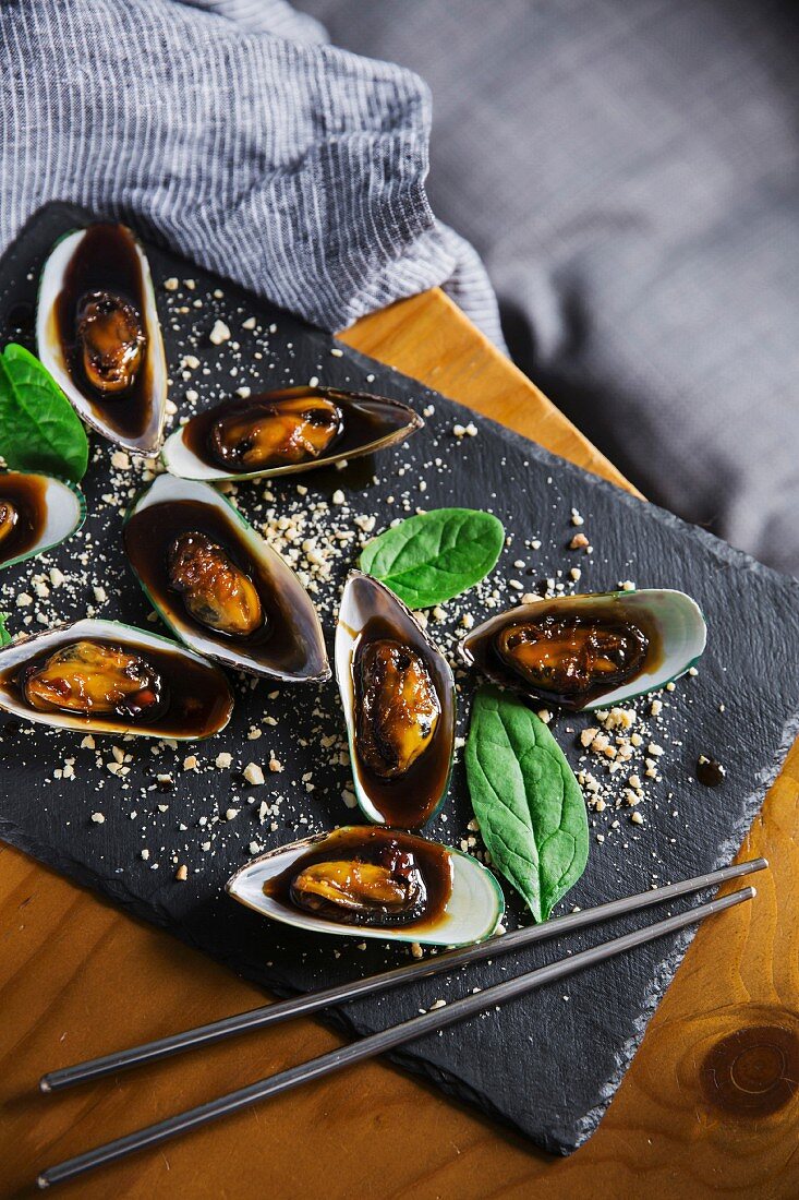 Asian dish - mussels in sticky sweet sauce, with peanuts and spinach