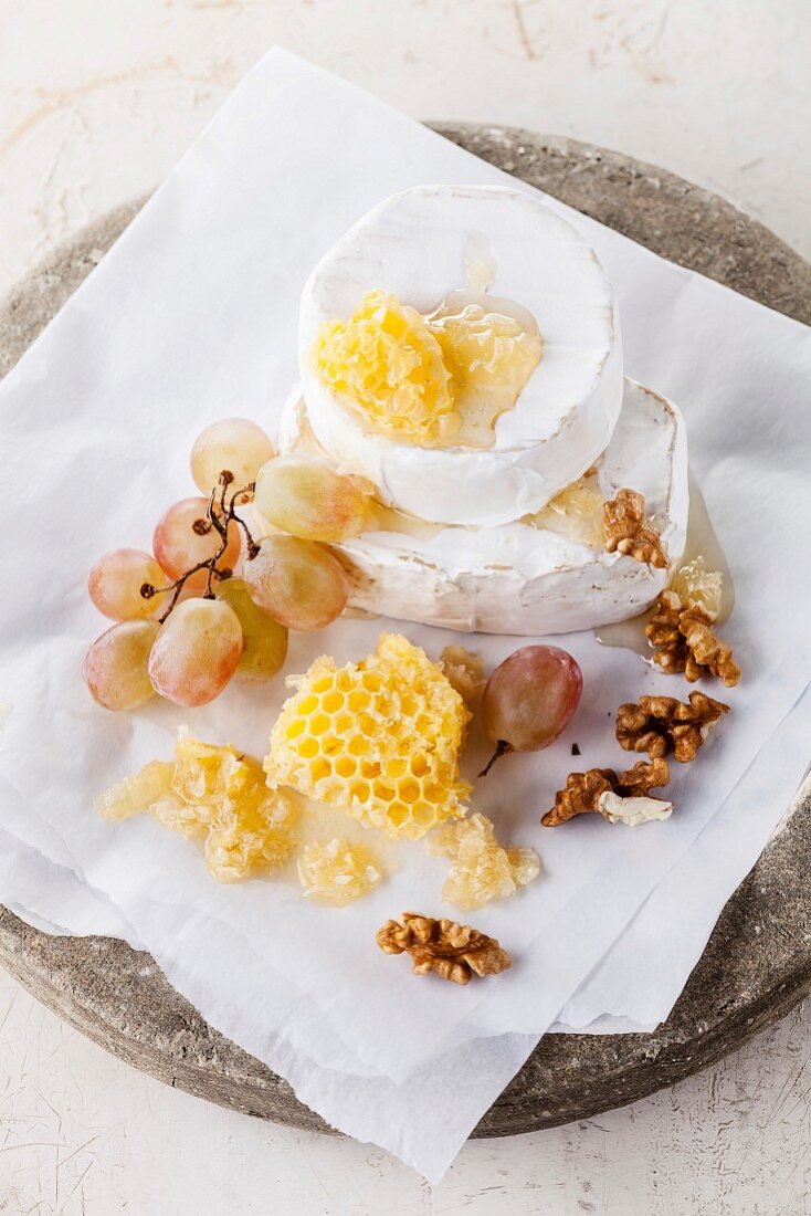 Cheese with honey, nuts and grapes