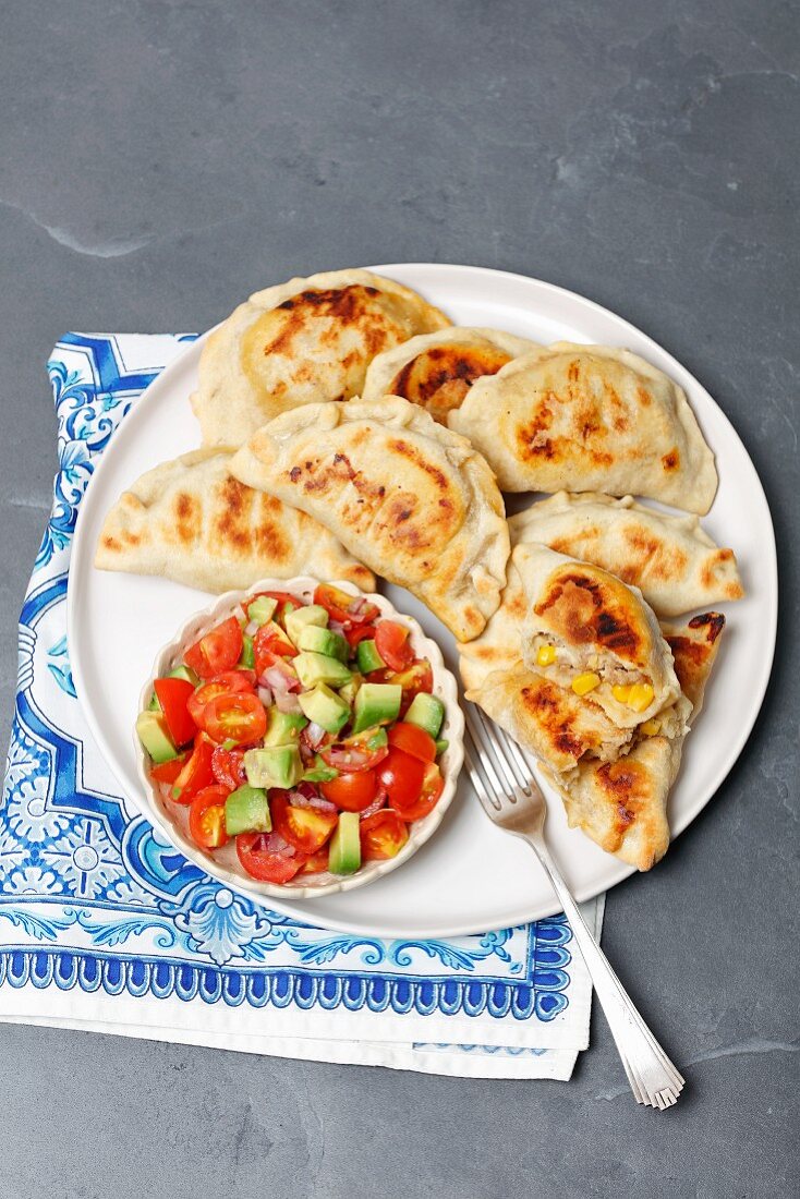 Baked empanadas with beef and corn, avocado and tomato salsa