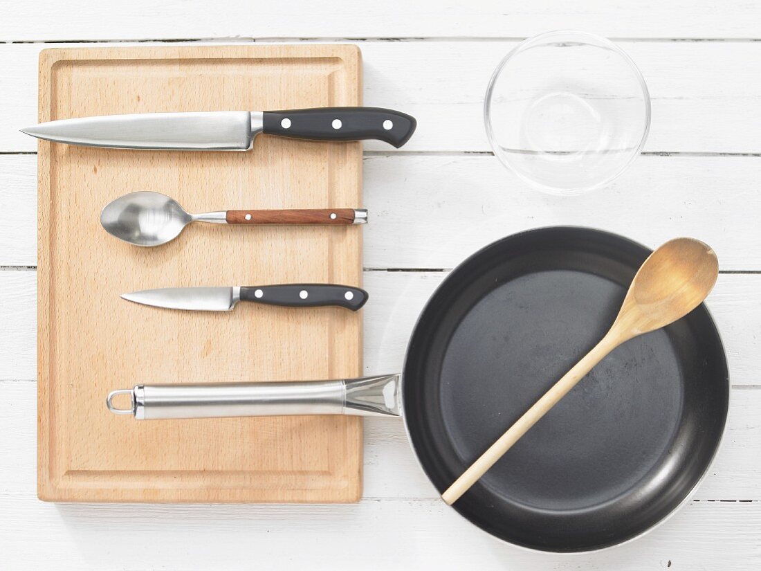 Various kitchen utensils: pan, spoon, knives