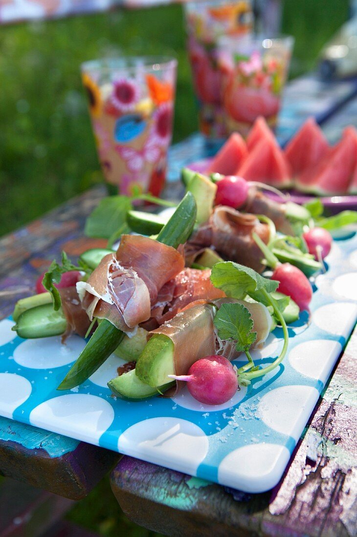Salad and tapas on colourful park bench, summertime