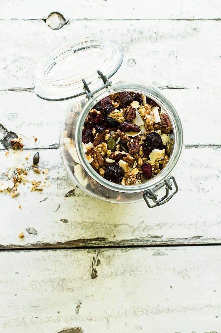 Cereal with pecans, pumpkin seeds, cranberries and oat flakes in a glass