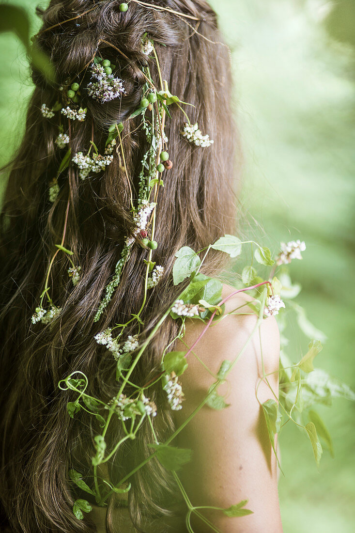 Girl with fairylike flowers twined in hair