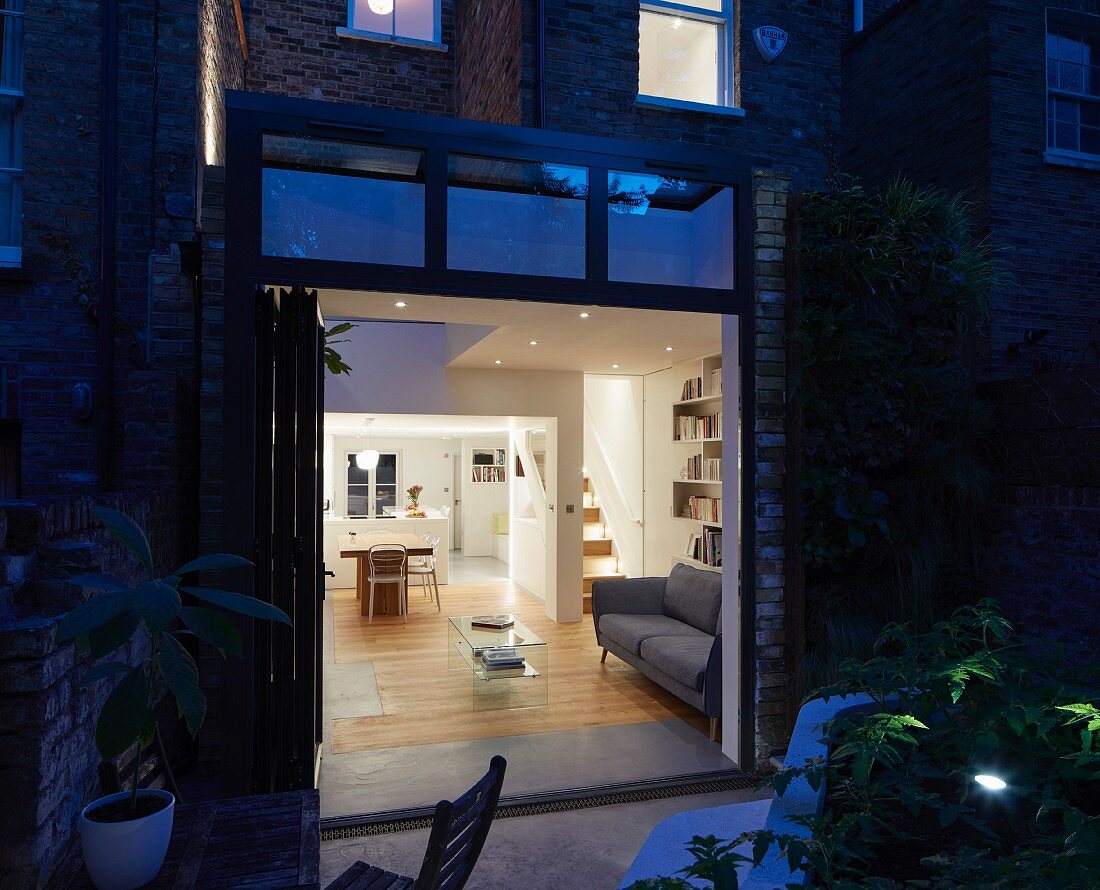 Angled view of sitting room from outside at dusk
