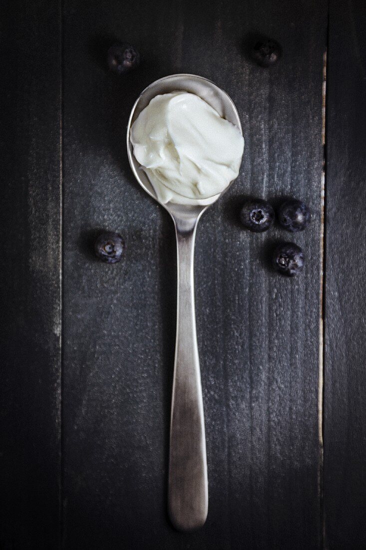 Yogurt on a spoon with blueberries