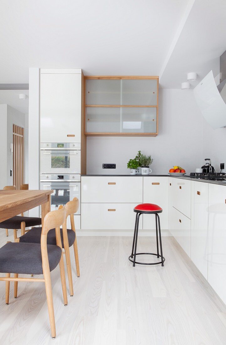 Scandinavian-style wooden chairs and dining table in kitchen