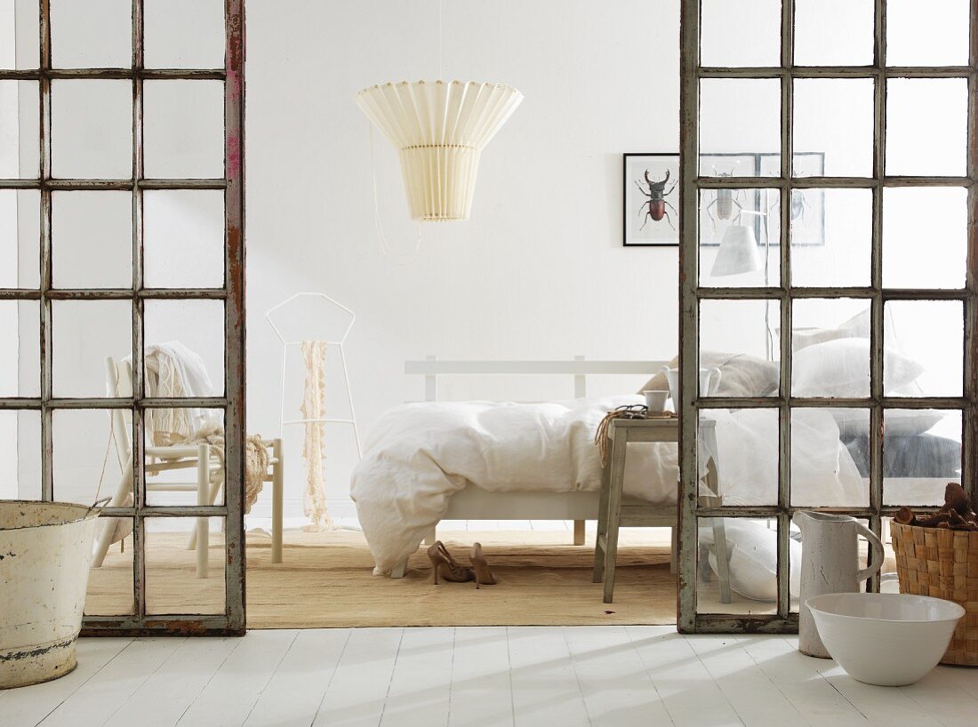 White bedroom with latticed glass doors