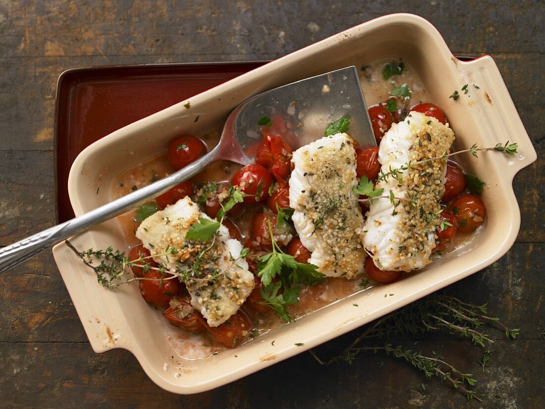 Fish fillets with an almond crust on a bed of cherry tomatoes