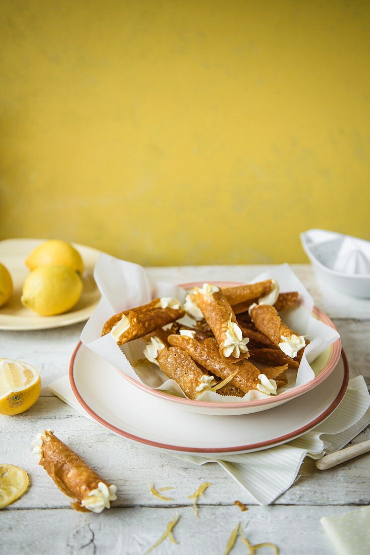 Brandy snap tuilles with lemon cream in a bowl.