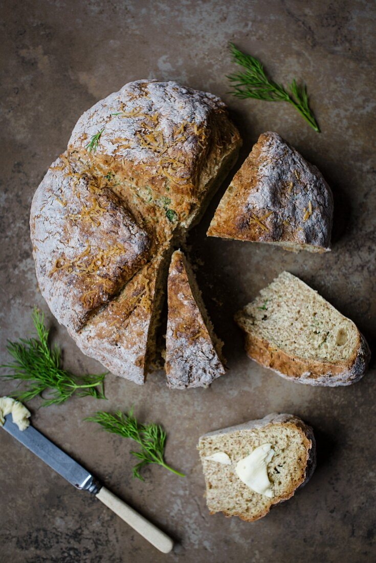 Homemade soda bread with cheese and dill, sliced, view from above