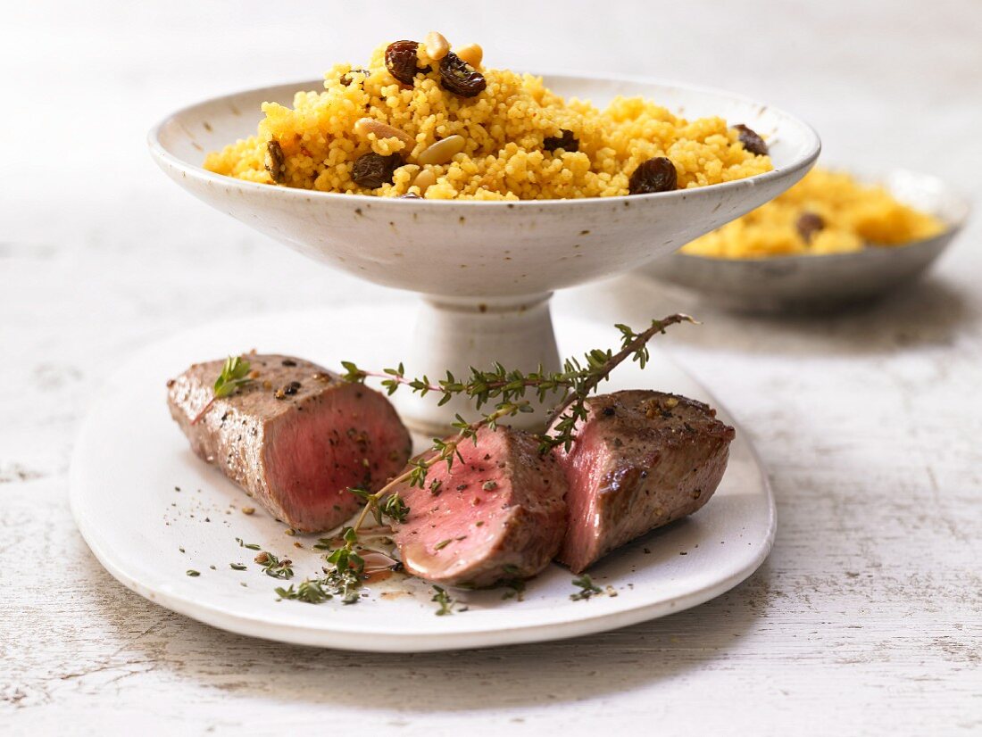 Lamb fillet and couscous with raisins, pine nuts and harissa