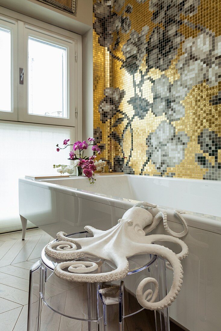 Octopus ornament on transparent stool next to bathtub