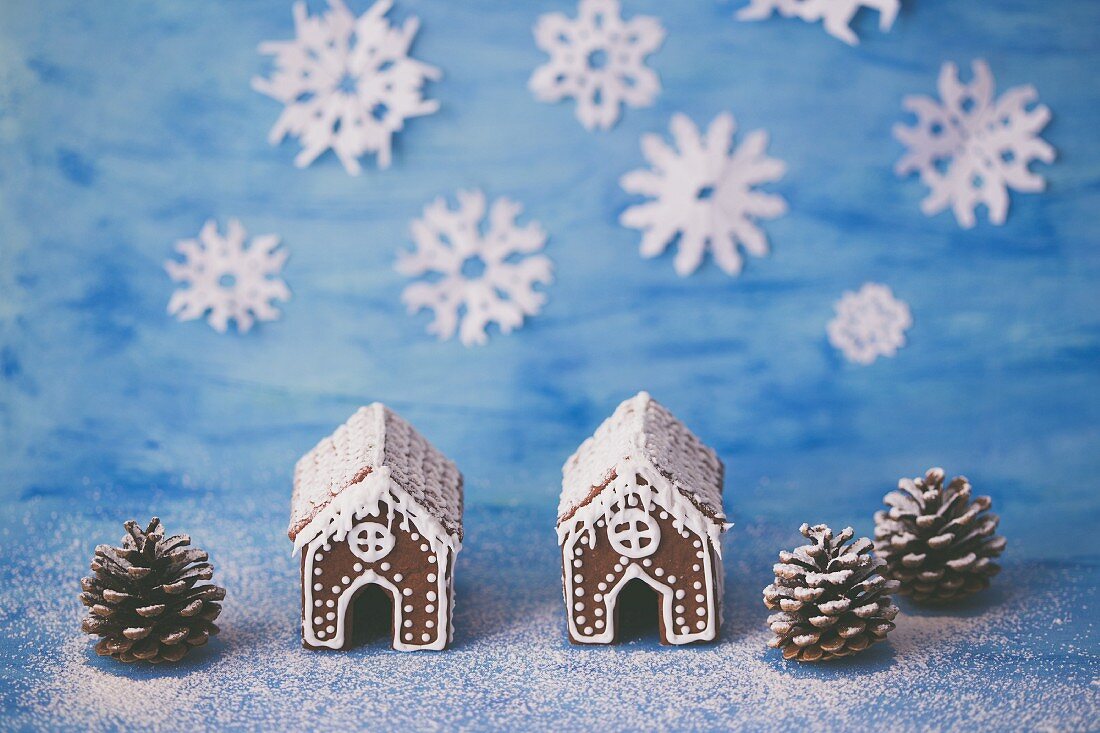 Two gingerbread houses decorated with royal icing
