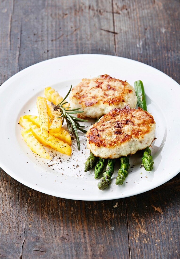 Fishcakes with french fries and asparagus