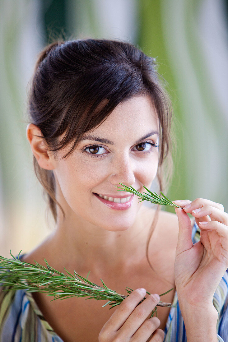 Woman smelling rosemary