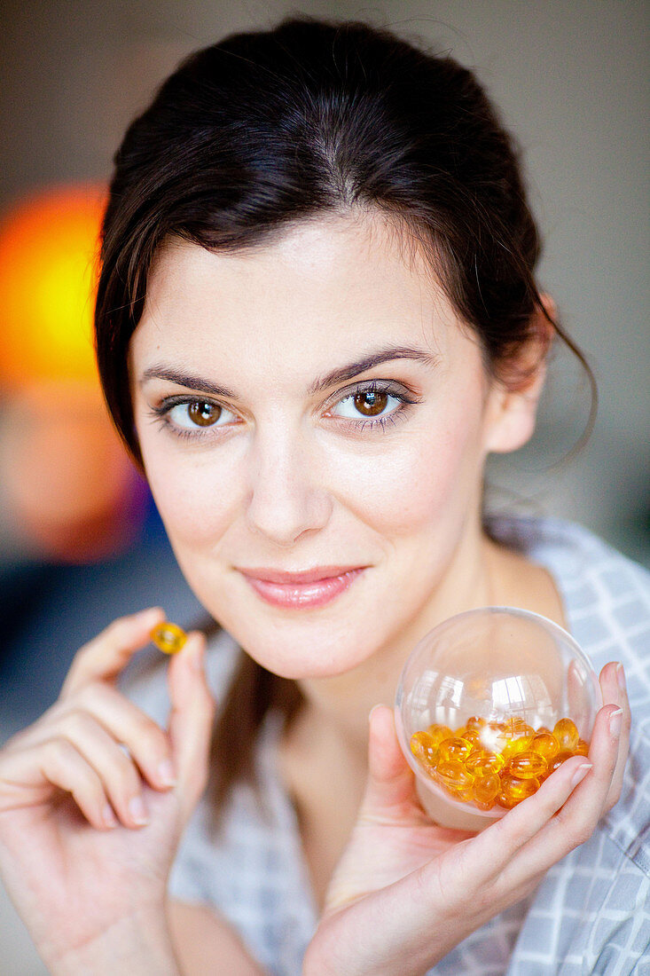 Woman taking food supplement