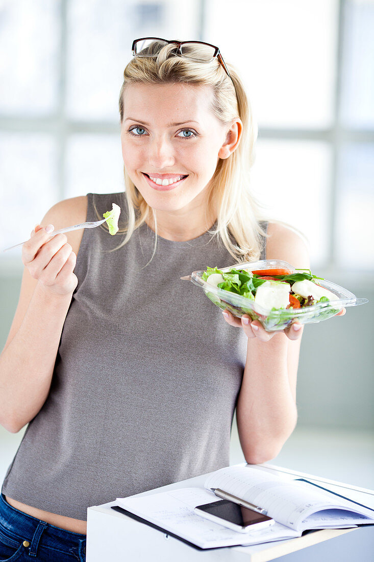 Woman eating tomato salad