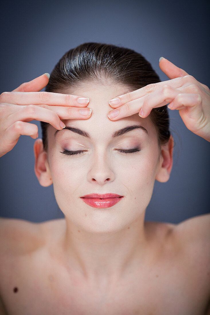 Woman massaging forehead