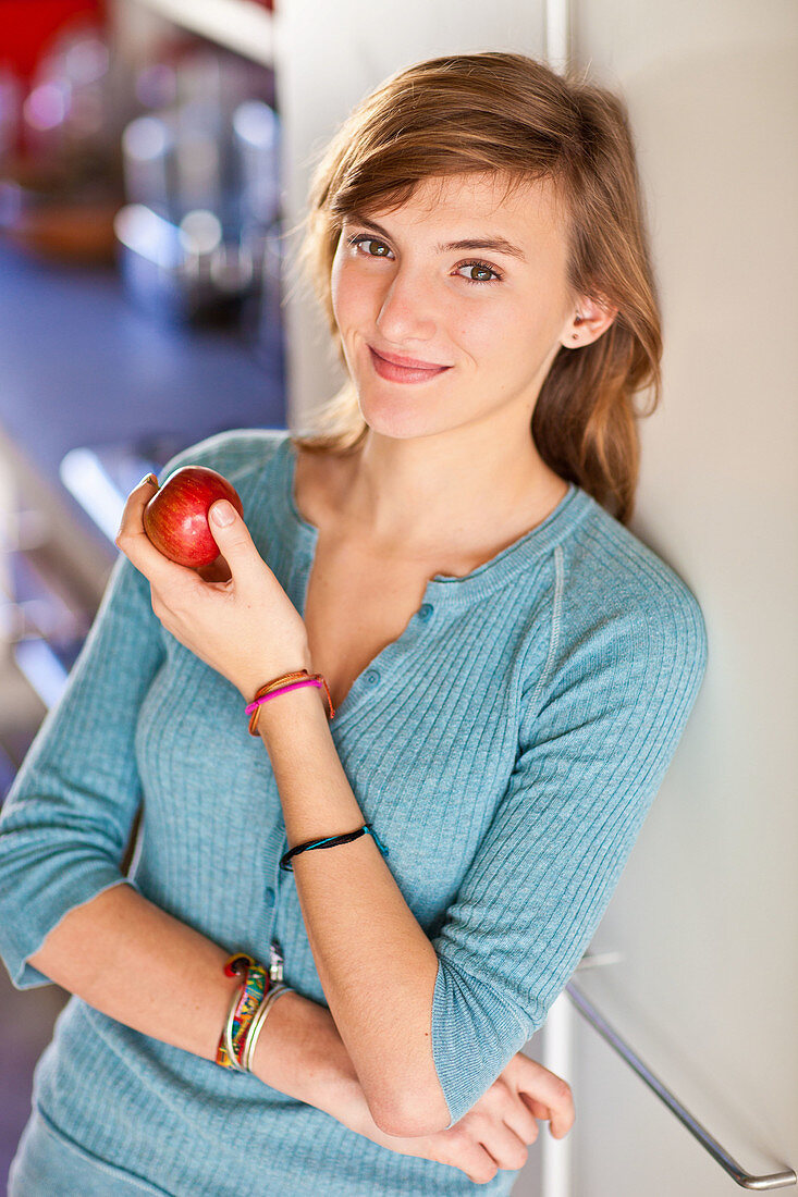 Teenage girl eating apple