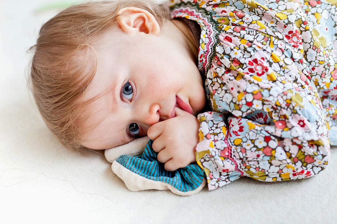 Baby girl sucking thumb