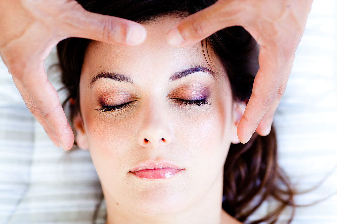 Woman receiving Reiki treatment