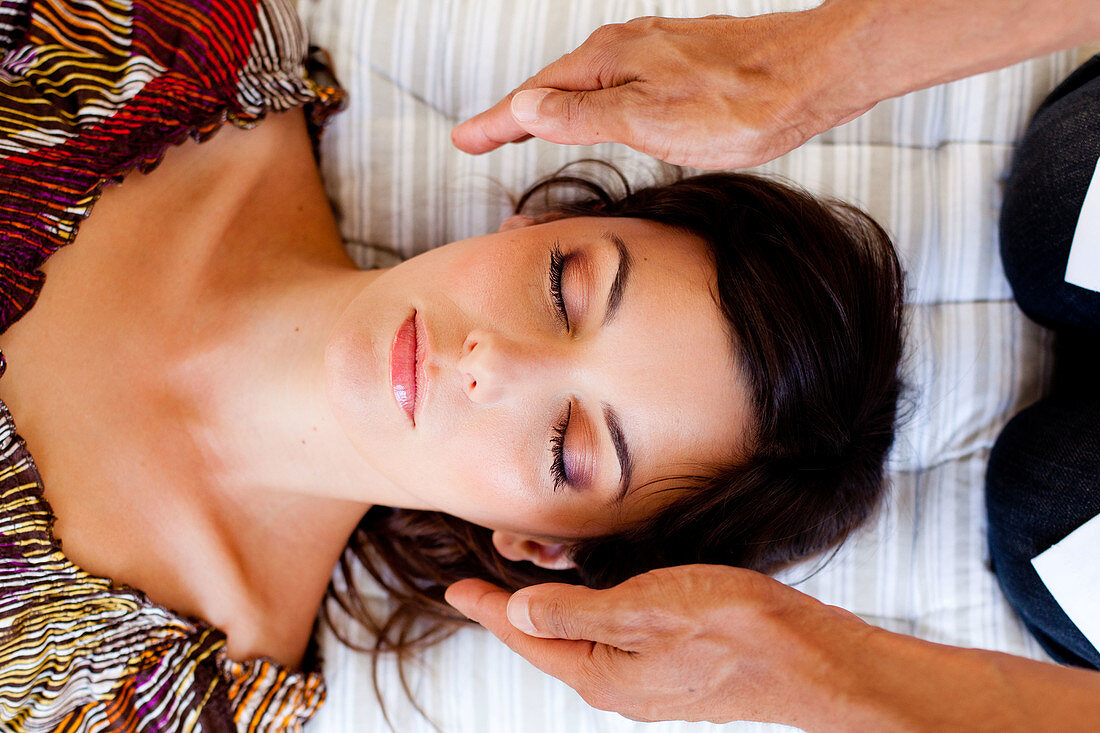 Woman receiving Reiki treatment