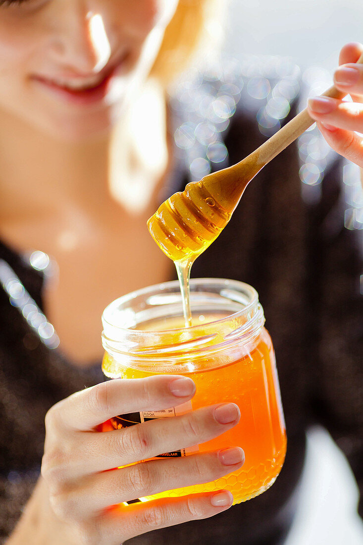 Woman eating honey