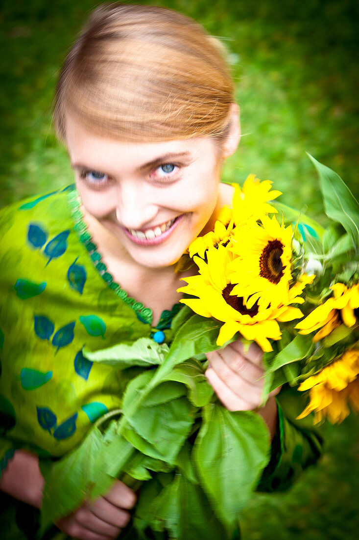 Woman holding sunflowers