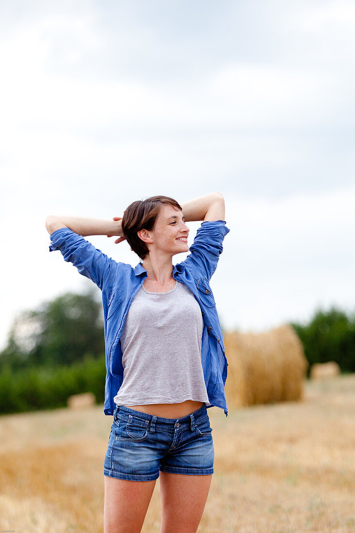 Woman stretching in a field