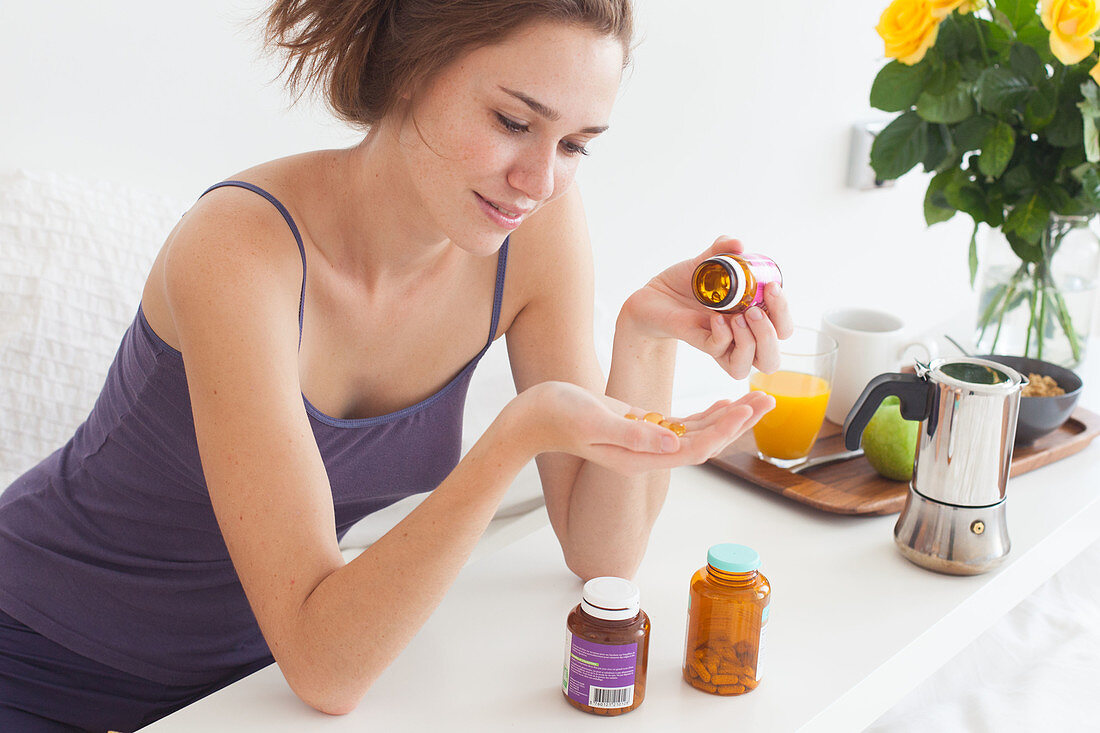 Woman taking food supplement