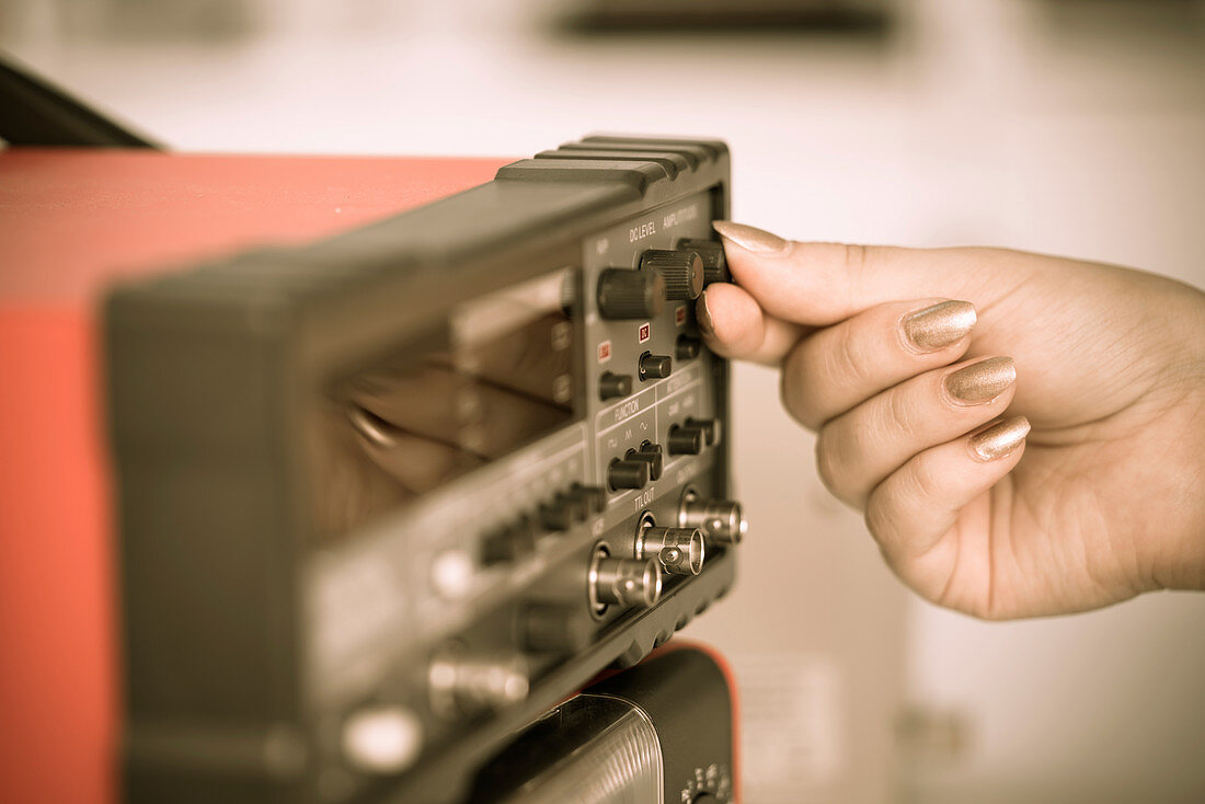 Person turning a dial on a telephone receiver