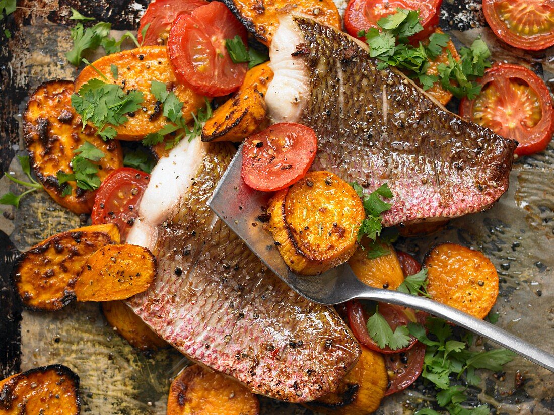 Oven baked red snapper fillets with sweet potatoes and tomatoes