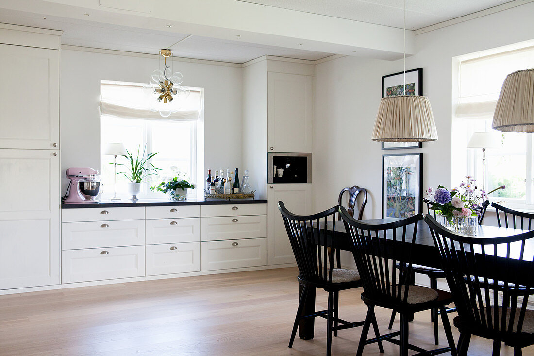 Black dining set in white country-house kitchen