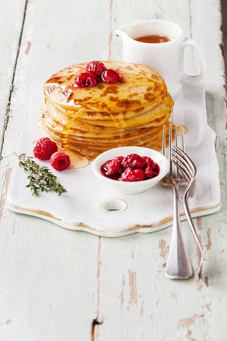 Small pancakes topped with raspberries