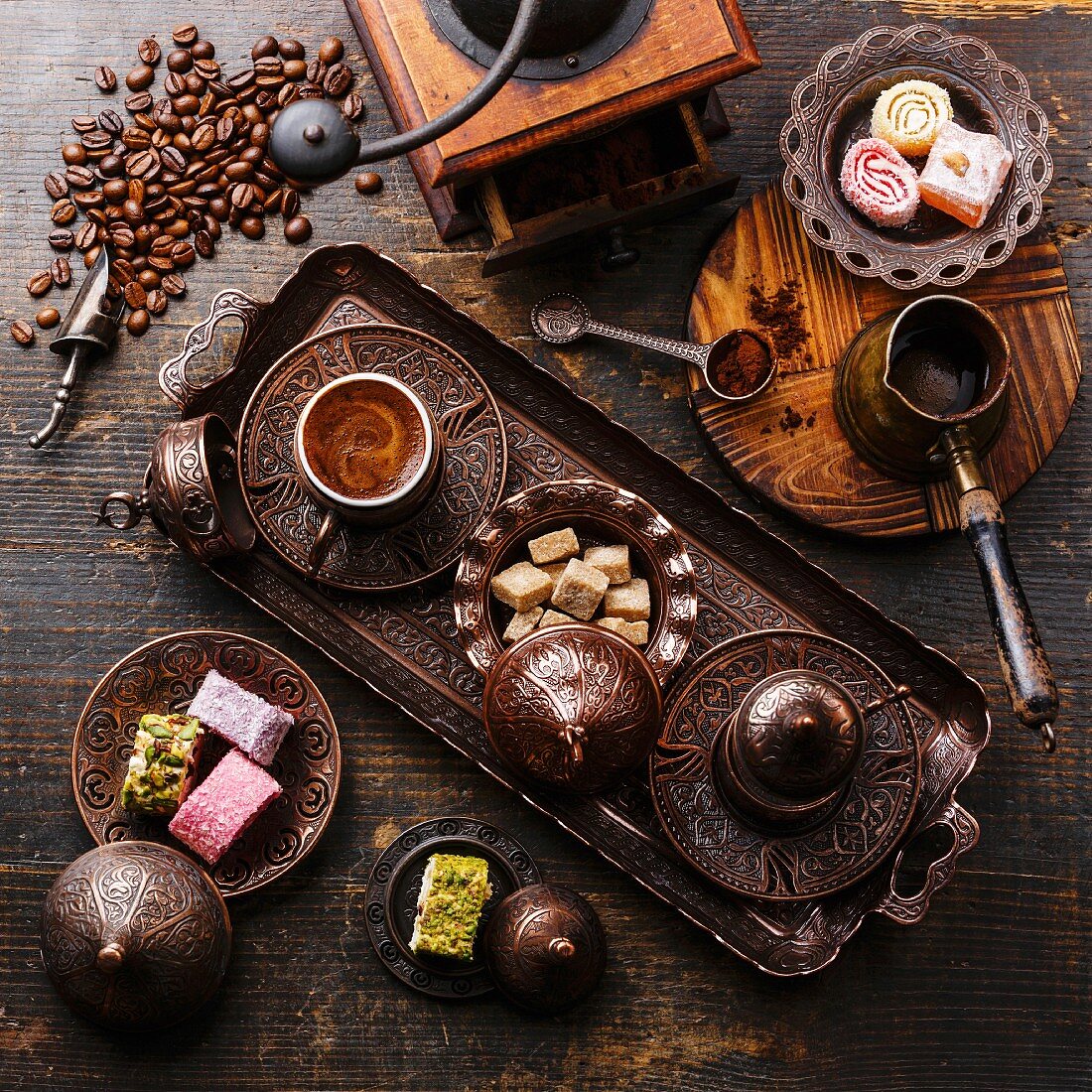 Coffee-east and Turkish Delight on copper tray on wooden background