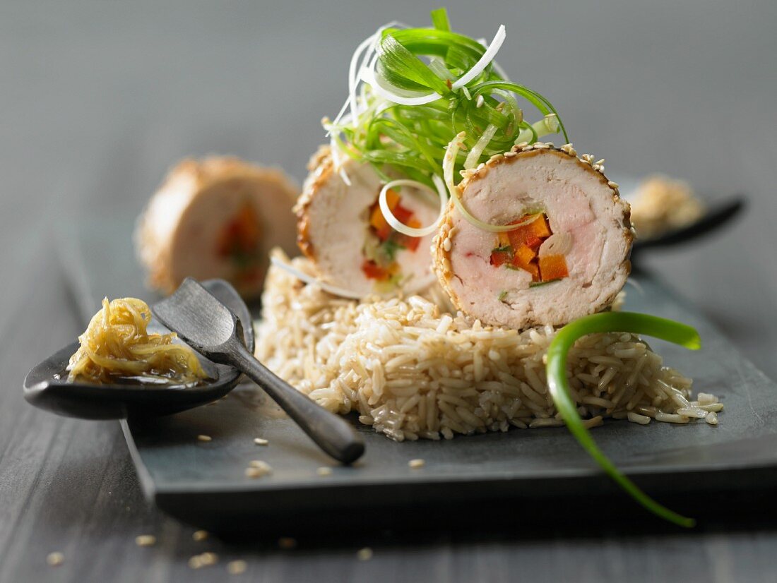 Chicken roulades with vegetables and sesame on rice