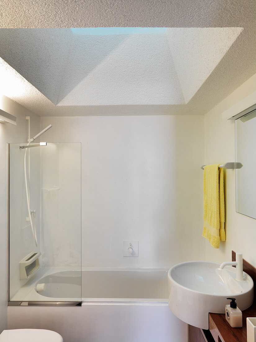 Shower tub below skylight in small bathroom