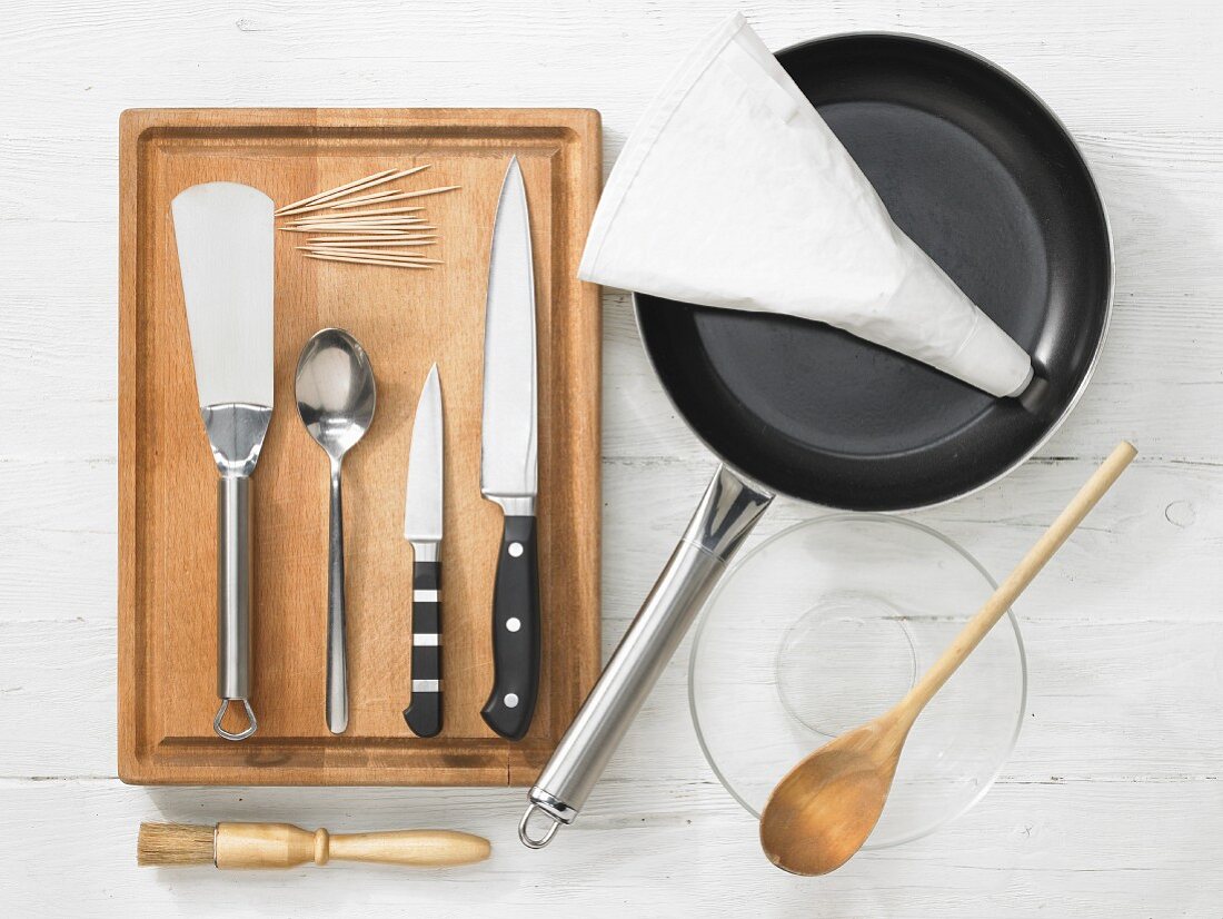 Various kitchen utensils: pan, piping bag, pastry brush, spatula