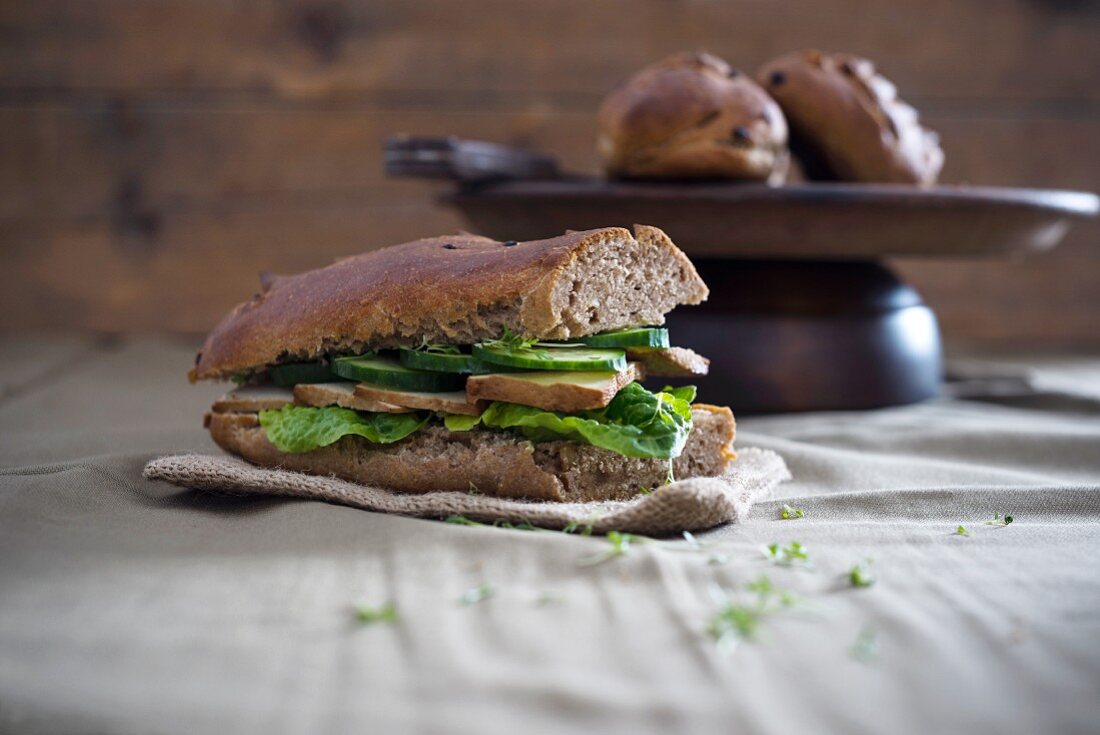 Vegan onion and walnut baguette, served with lettuce, smoked tofu, cucumber salad and cress