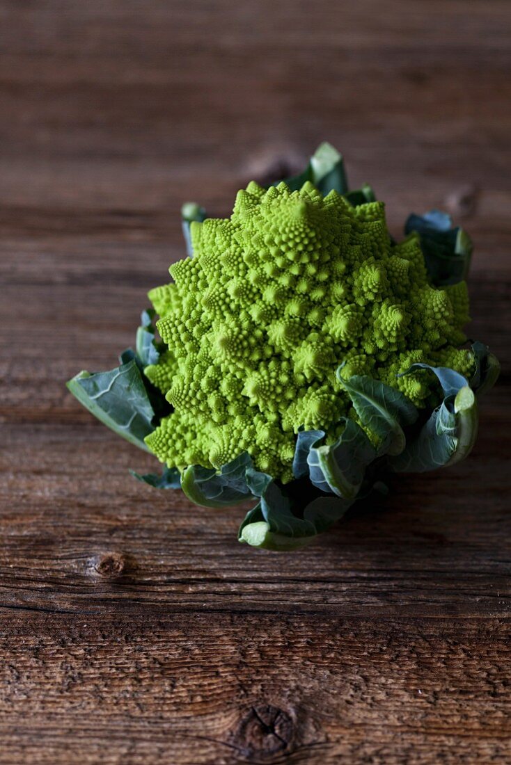 Head of Romanesco broccoli on a rustic wooden table