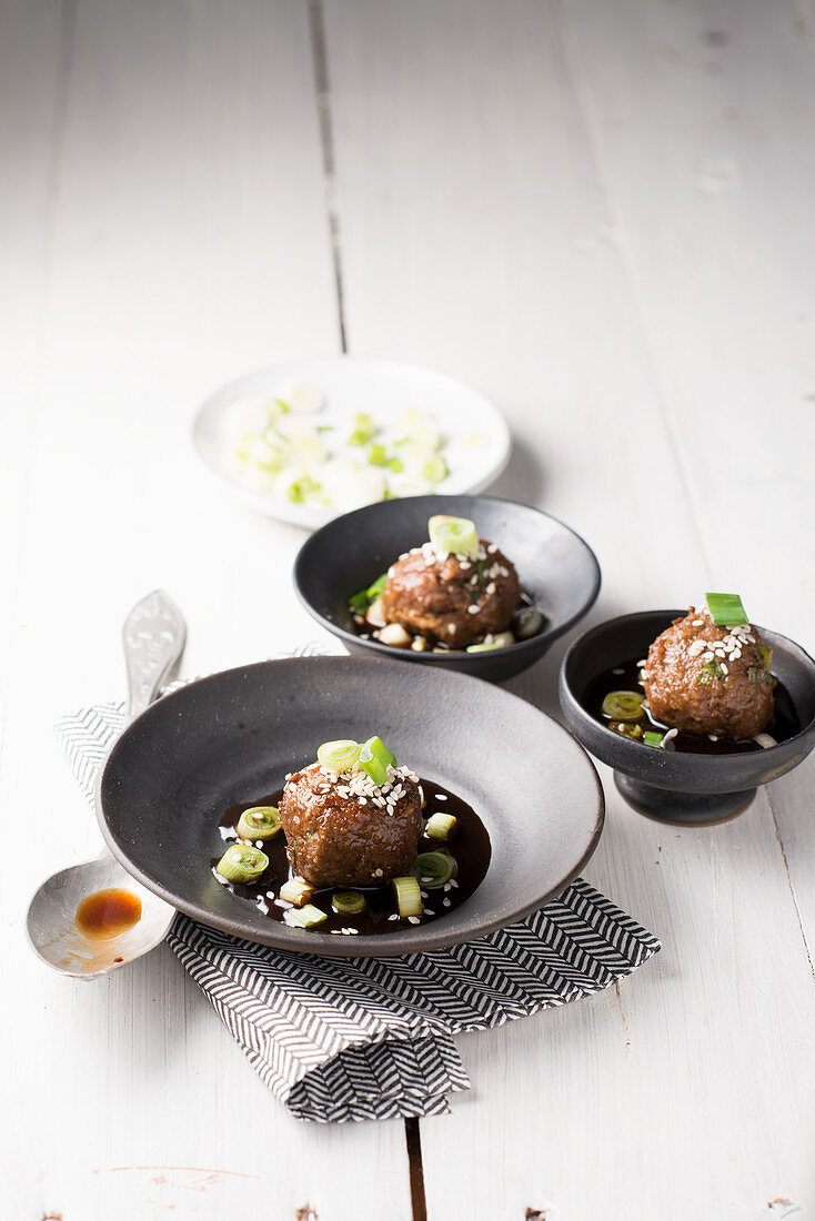 Meatballs in teriyaki sauce with spring onions