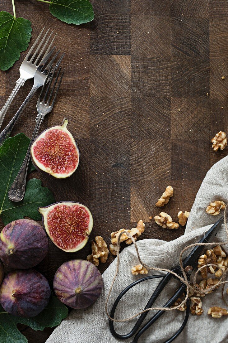 Fresh figs and walnuts on a wooden surface