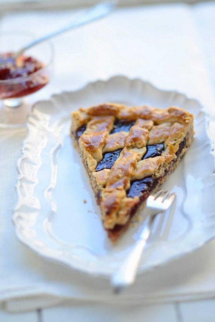 A piece of Linzertorte on a vintage plate