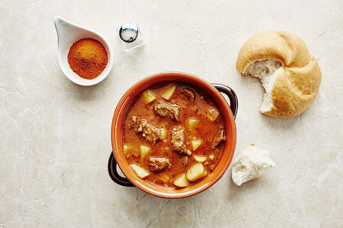 Goulash soup with potatoes and bread rolls