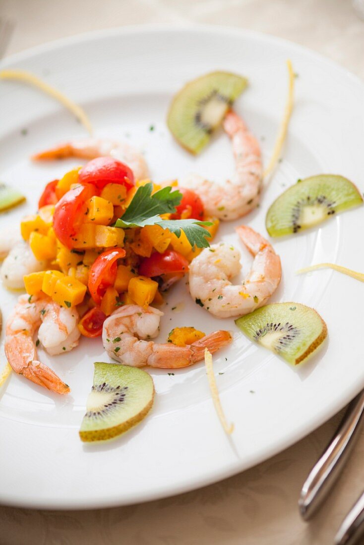 Shrimp with pumpkin cubes, cherry tomatoes and kiwi slices