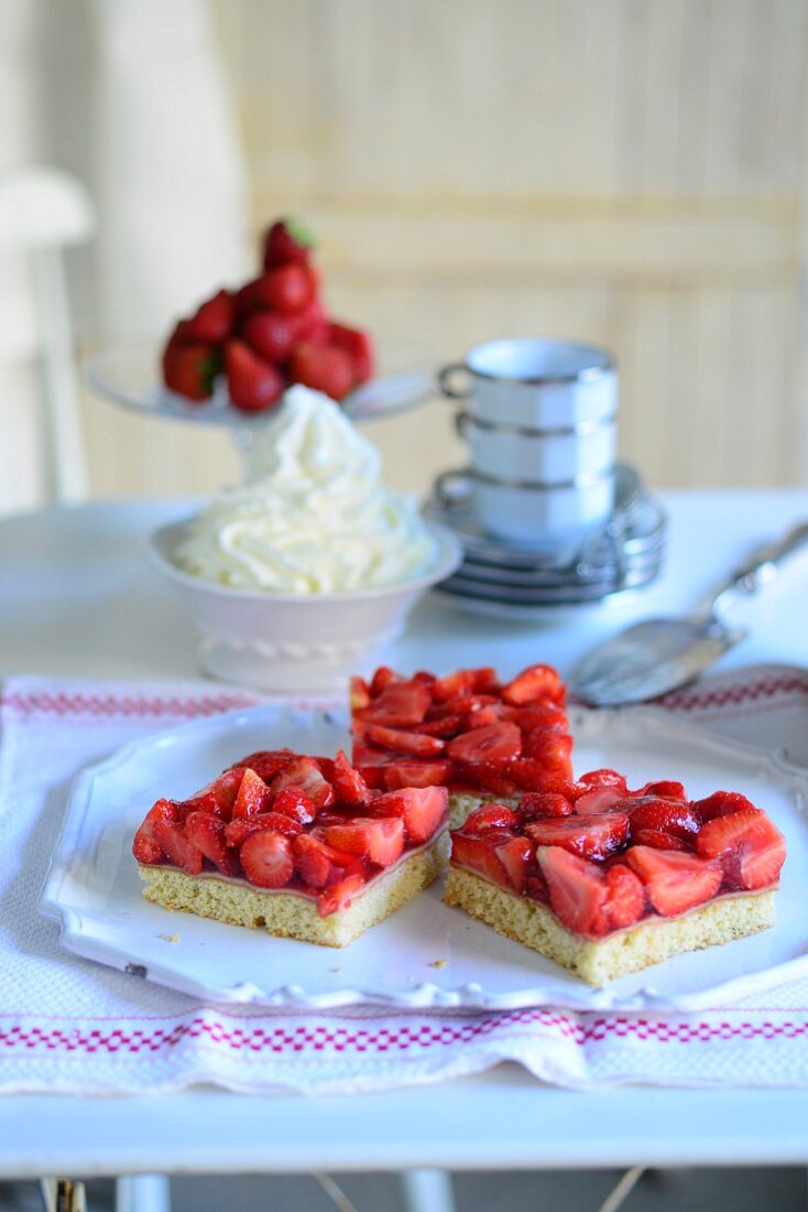 Three pieces of strawberry cake with whipped cream