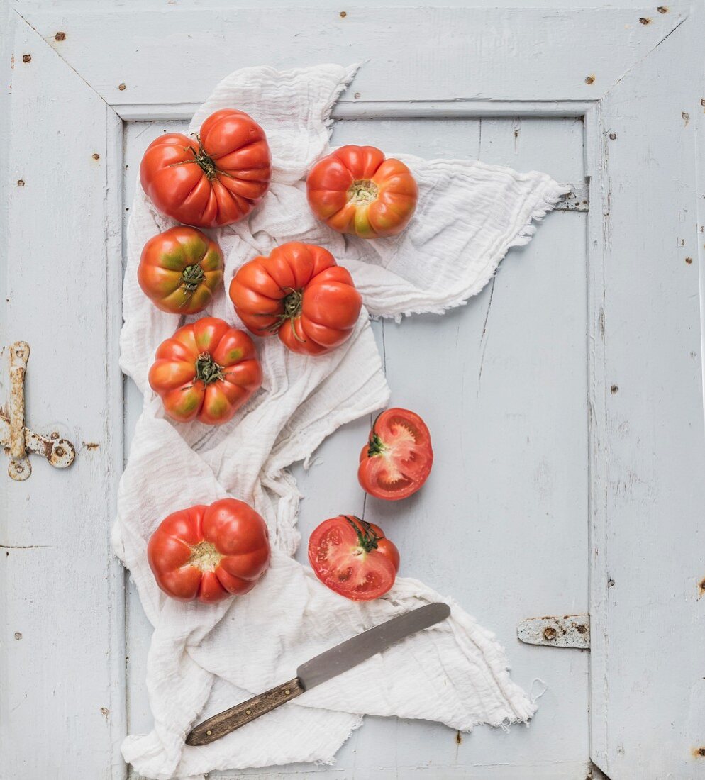 Fresh ripe hairloom tomatoes on rustuc blue wooden surface